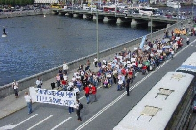 Bild från Marschen för tillgänglighet 2004; hela det långa marschtåget ses strax innan Mynttorget. Hälften av det passerar strömbron och svänger av mot Mynttorget. Foto: Ilias Bennani